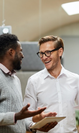 Stock photo of two men smiling at each other