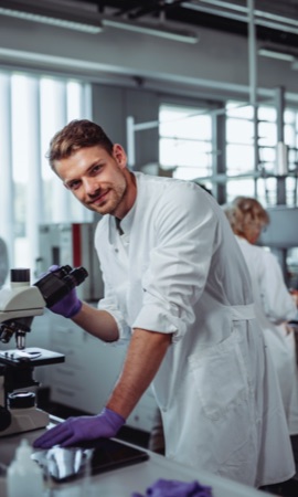 A man smiling while in the laboratory